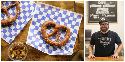 Philip Given standing in front of York City Pretzel Company menu